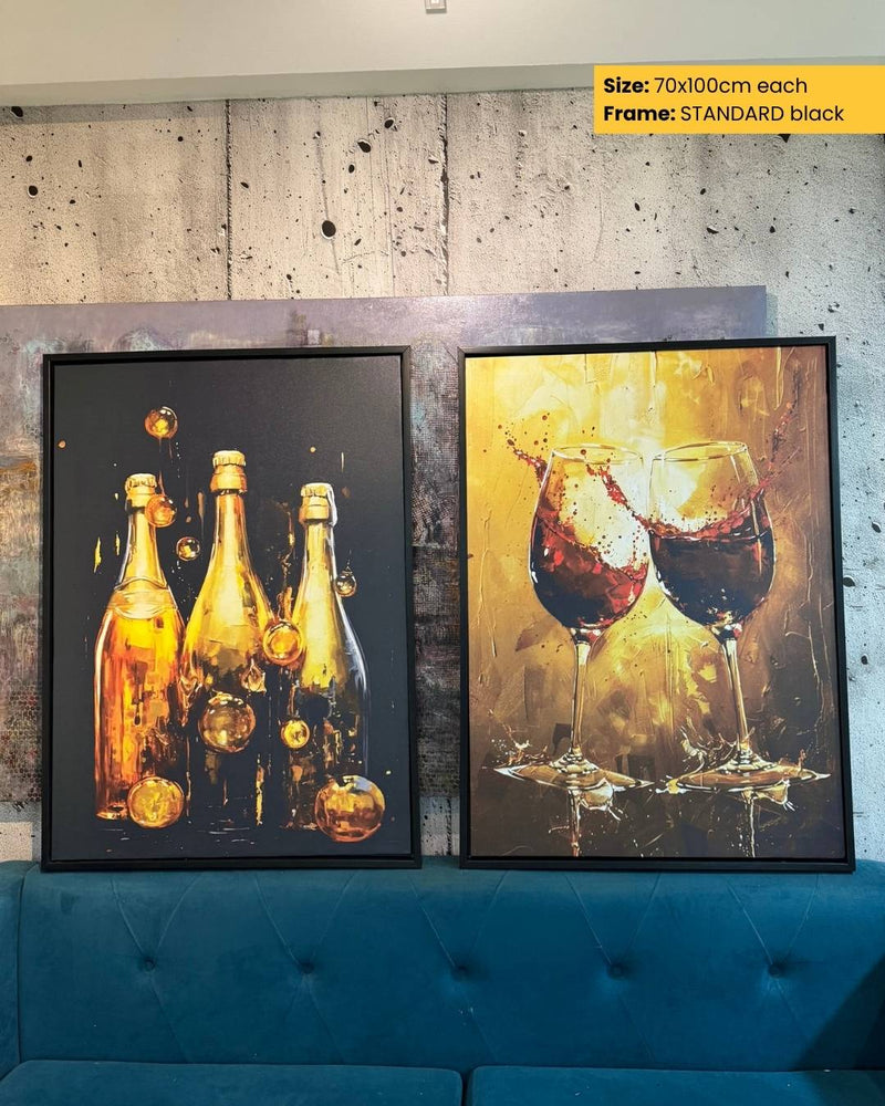 Two framed artworks on a wall with a blue sofa below.