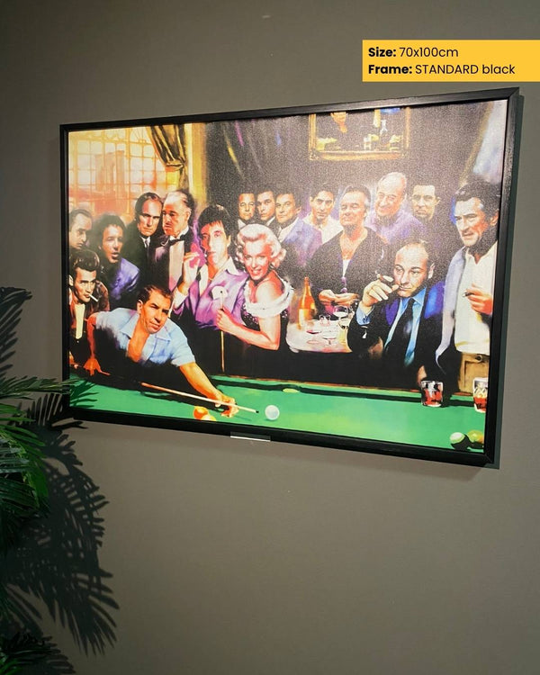 Framed artwork of a group of people around a pool table on a wall.