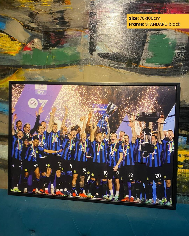 Framed photo of a sports team celebrating with a trophy against a colorful abstract background.