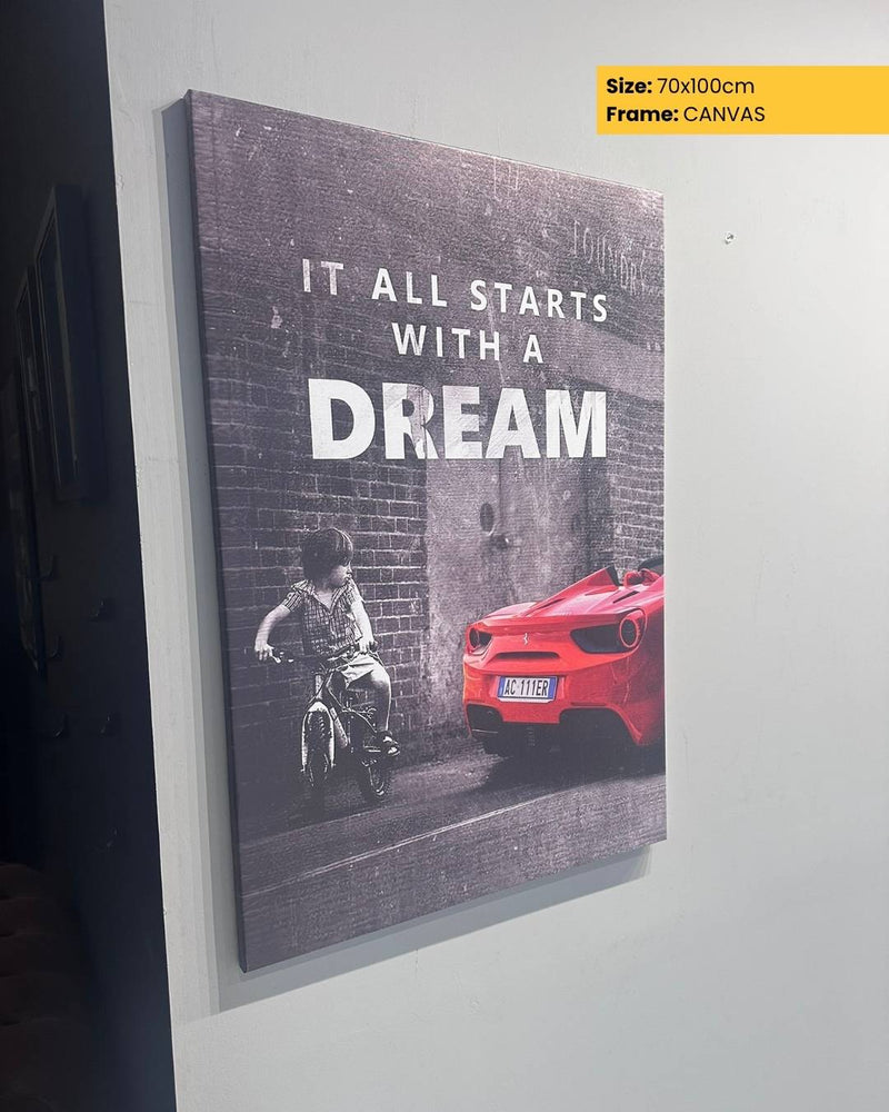 Canvas print with a child on a bike and a red car, featuring the text 'It all starts with a dream'.