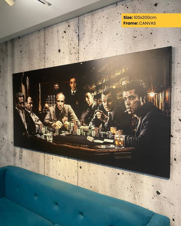 Large canvas print of a group of men around a table in a dimly lit room, displayed on a textured wall with a blue sofa.