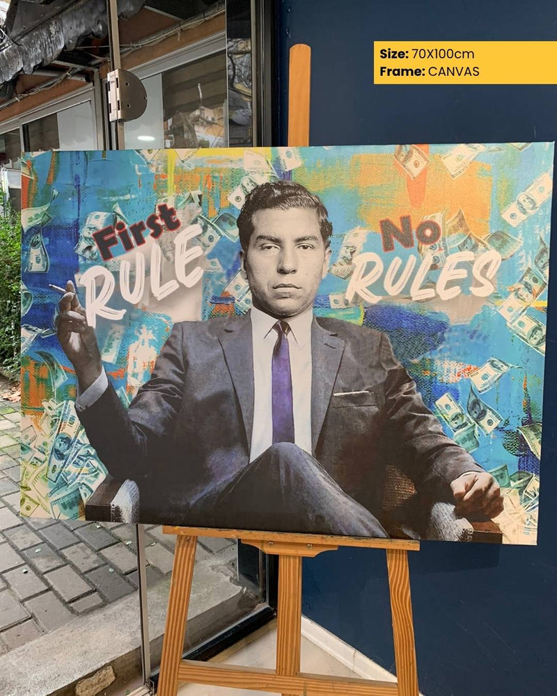 Canvas print of a man in a suit with 'First Rule' and 'No Rules' text on a colorful background, displayed on an easel.