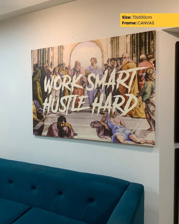 Canvas print with classical painting and motivational text on a wall above a blue sofa.