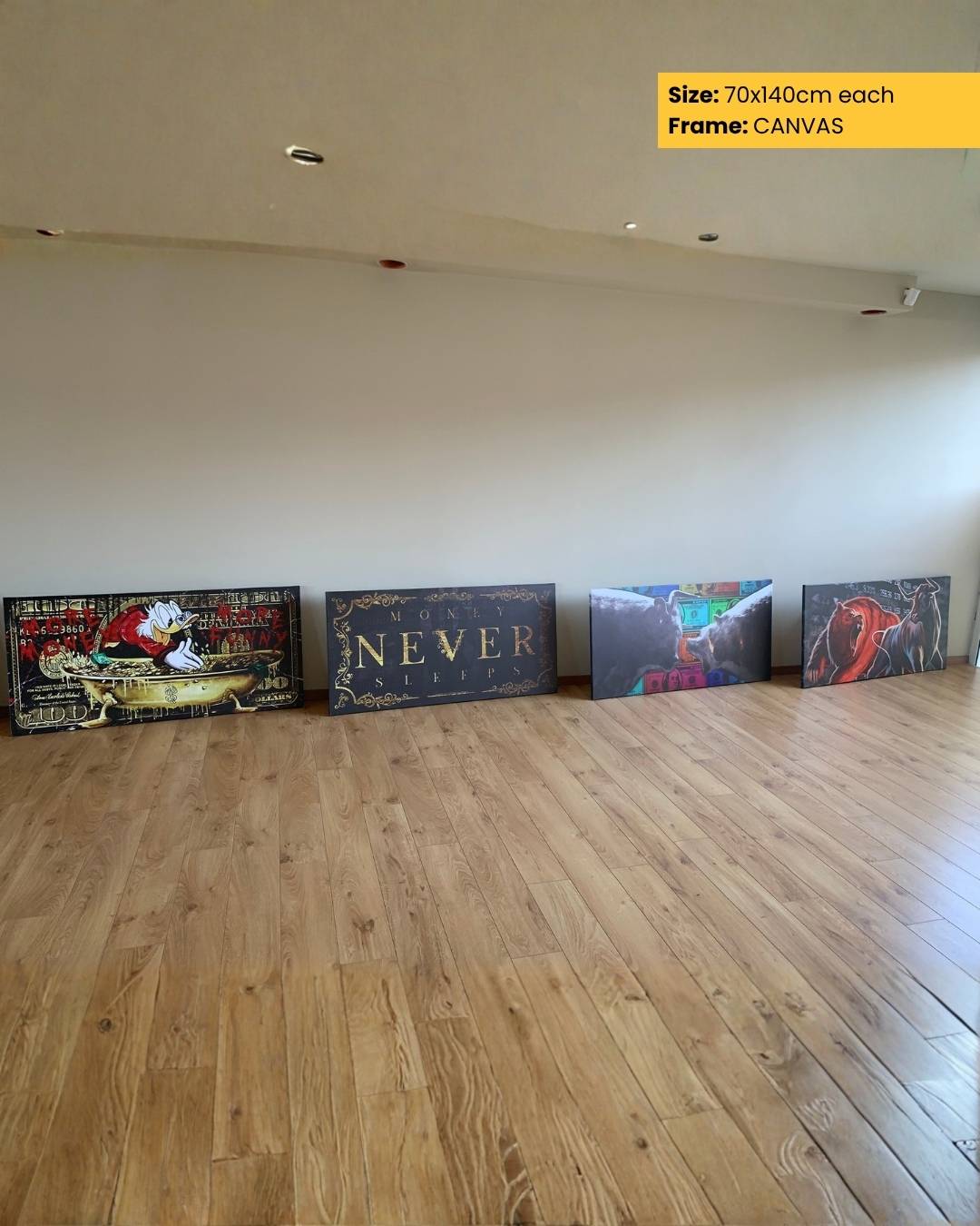 Four canvases of different sizes and designs on a wooden floor with a plain wall background.