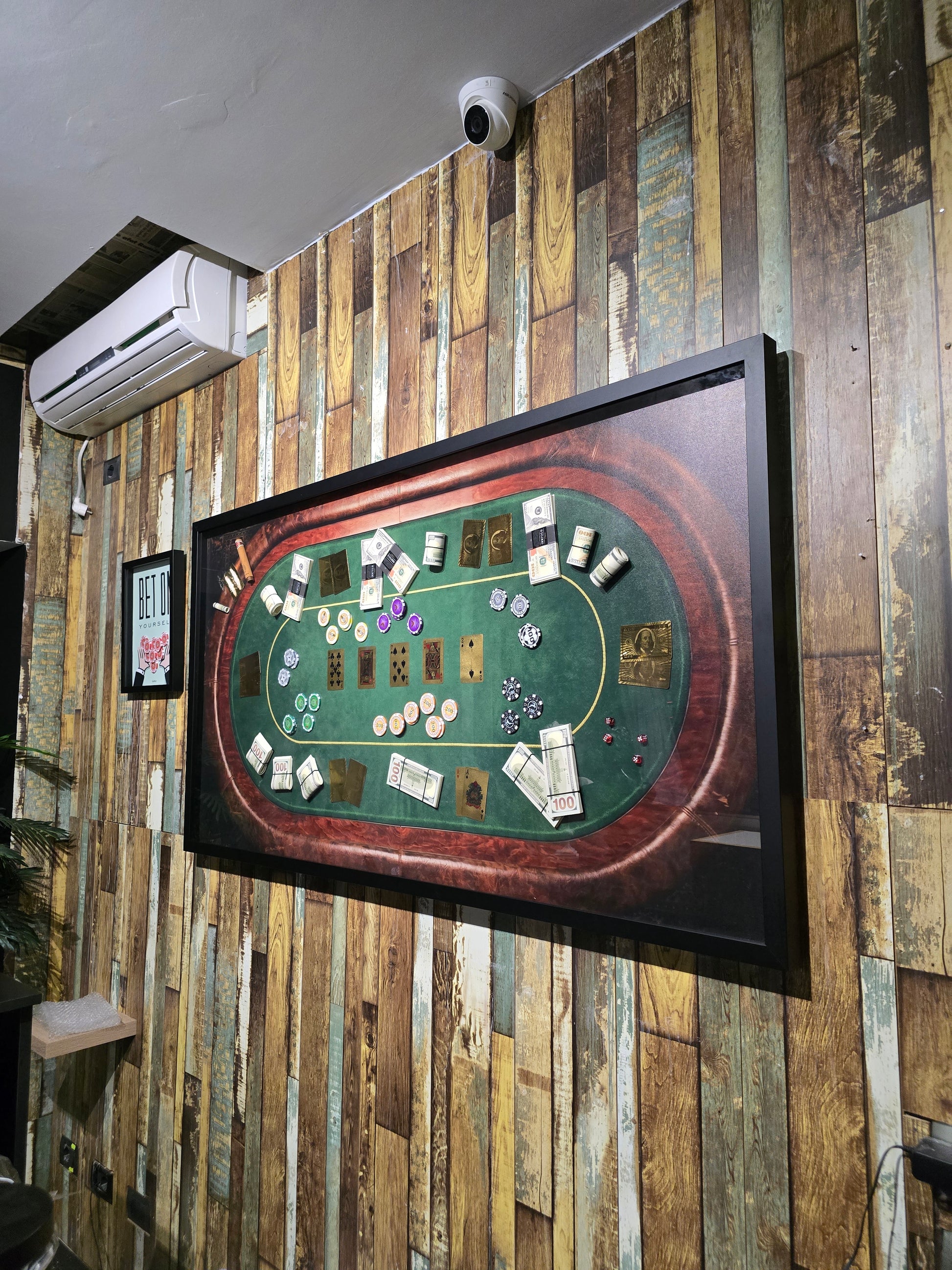 Wooden poker table with cards and chips on a wooden wall background
