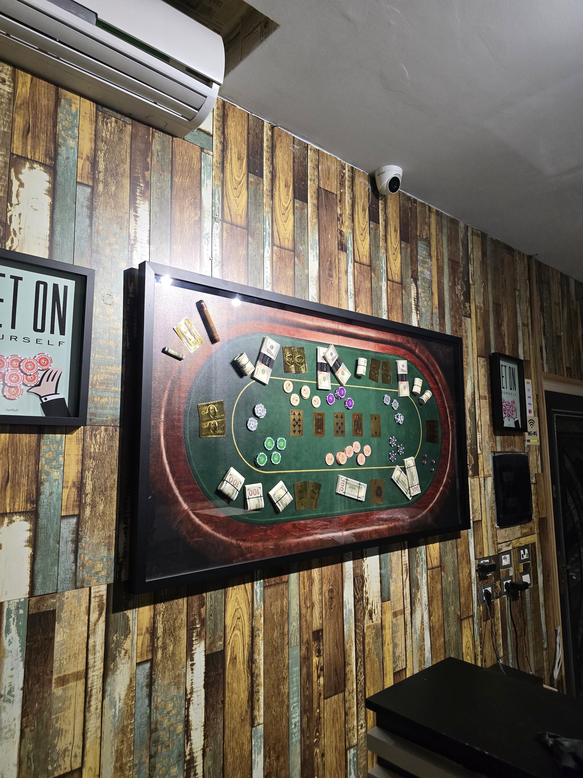 Poker table setup on a wall with wooden paneling