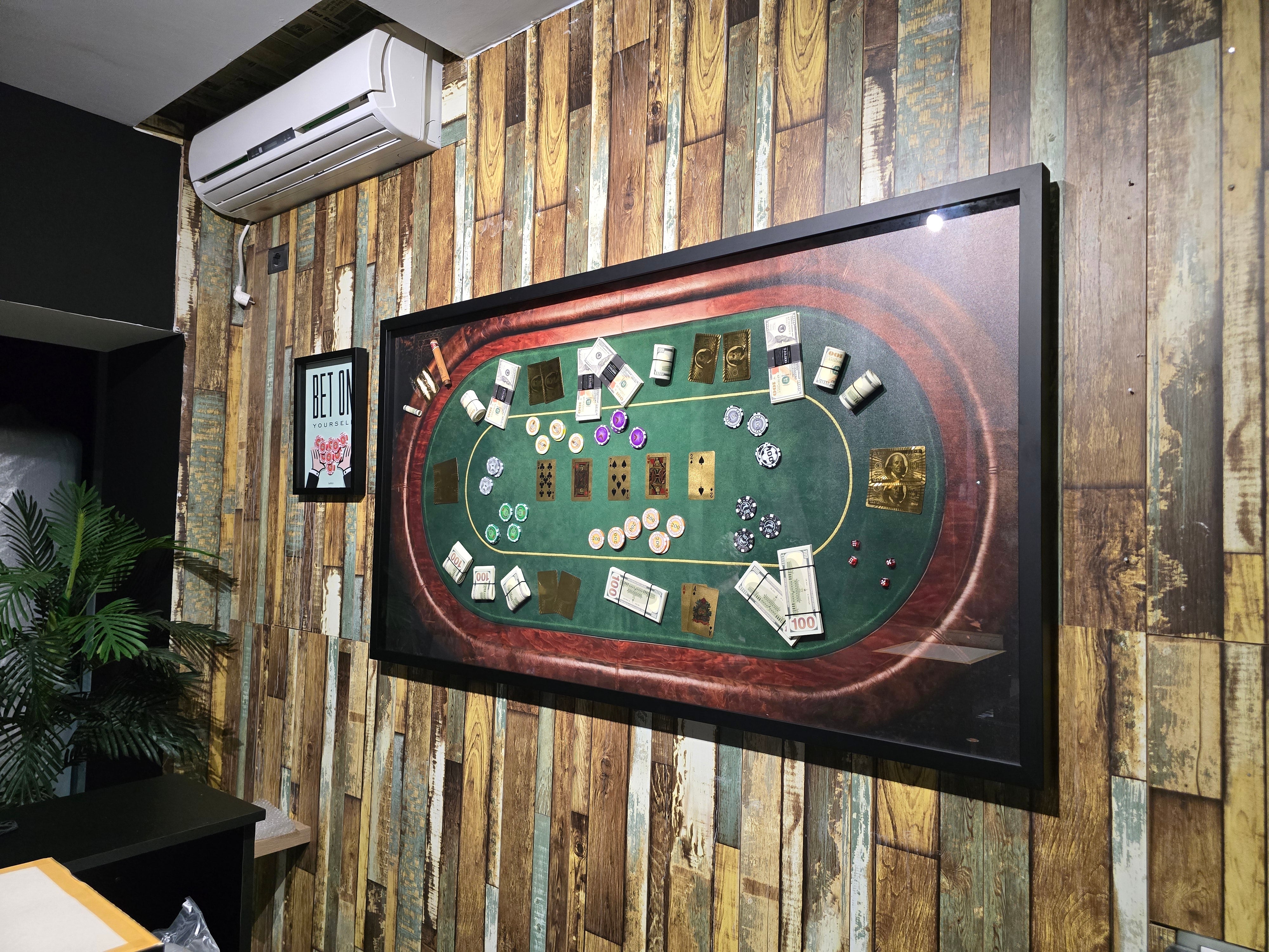 Poker table setup on a wall-mounted screen in a room with wooden paneling.