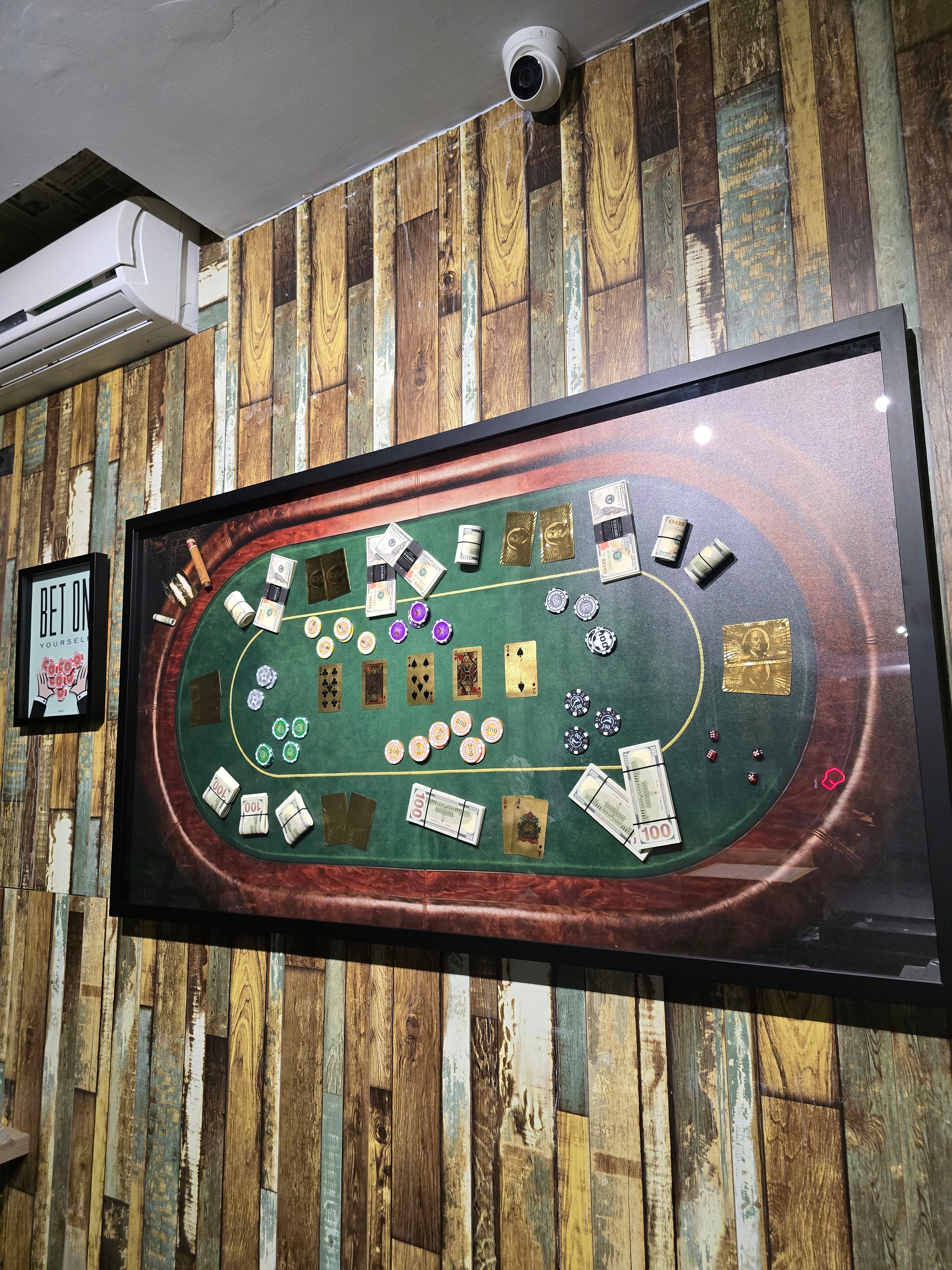 Poker table setup with cards and chips on a wooden wall background