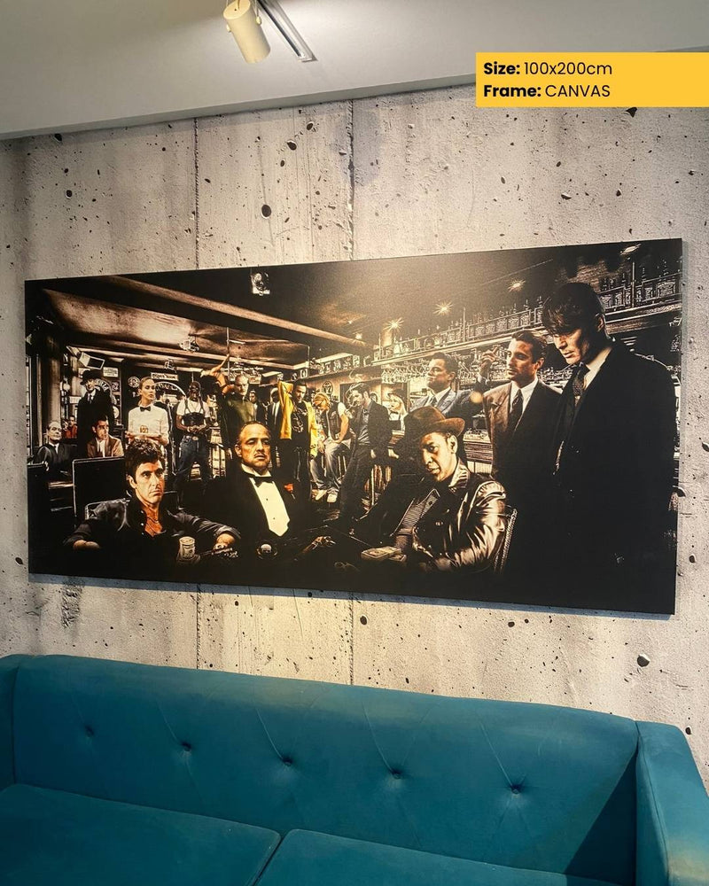 Large canvas print of a group of people in a room, displayed on a wall above a blue sofa.