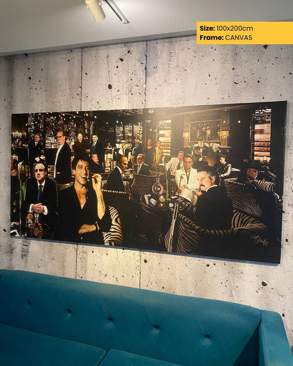 Large canvas print of a group of people in a bar setting on a wall above a blue sofa.