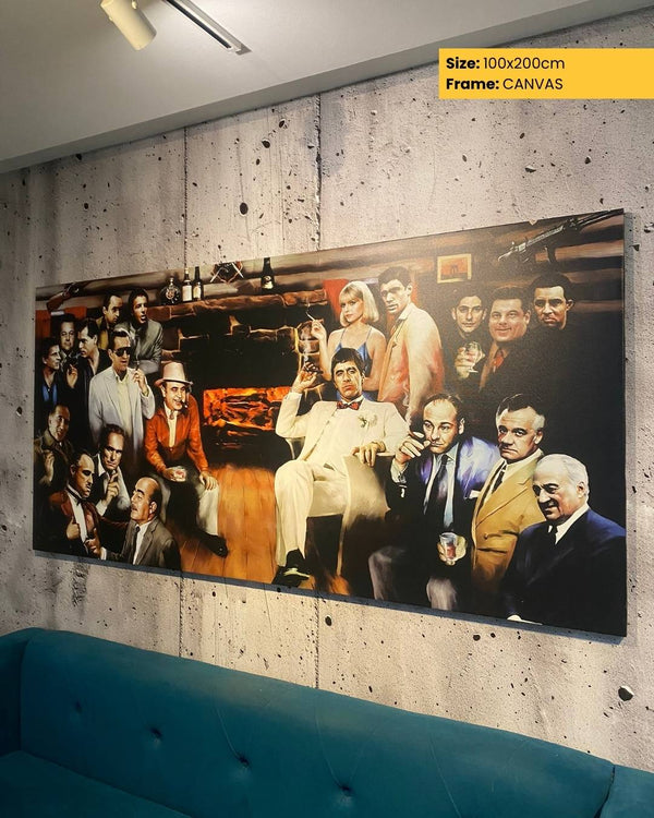 Large canvas print of a group of people in a room, displayed on a wall above a blue sofa.
