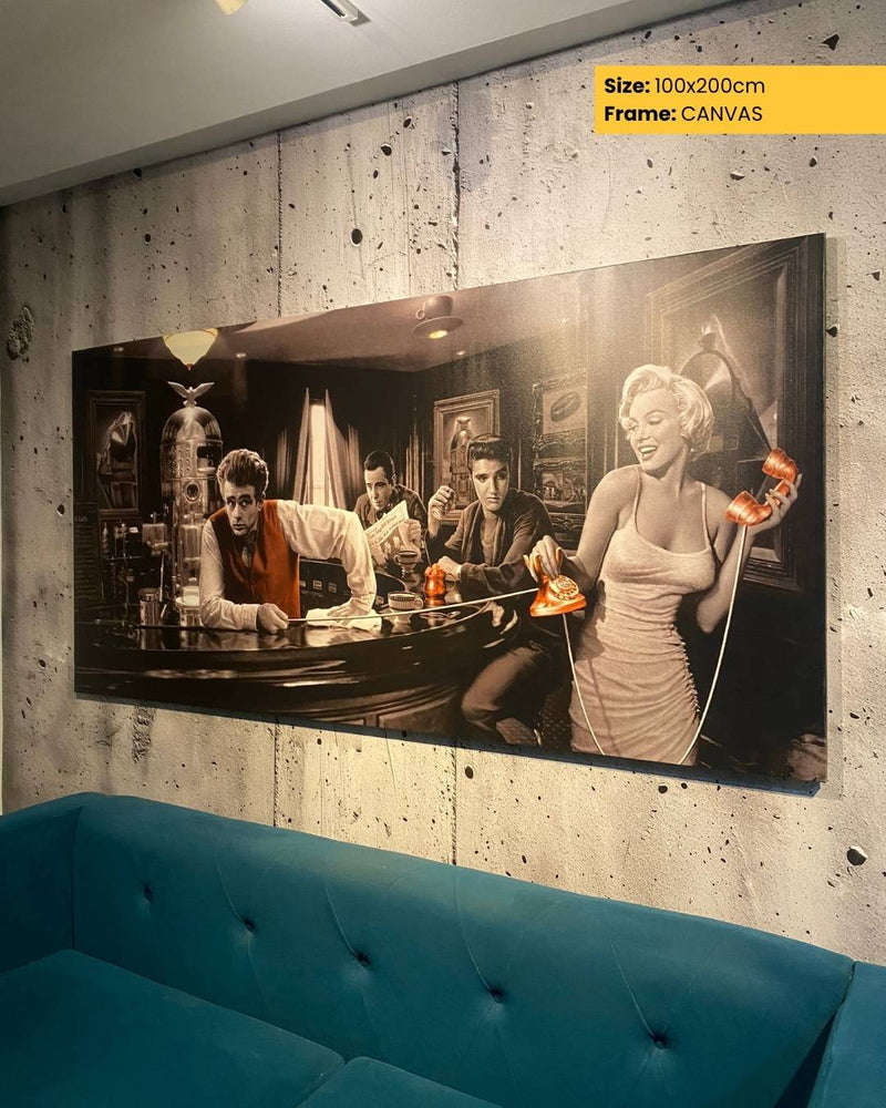 Large canvas print of a vintage scene with people at a bar, hanging on a textured wall above a blue sofa.