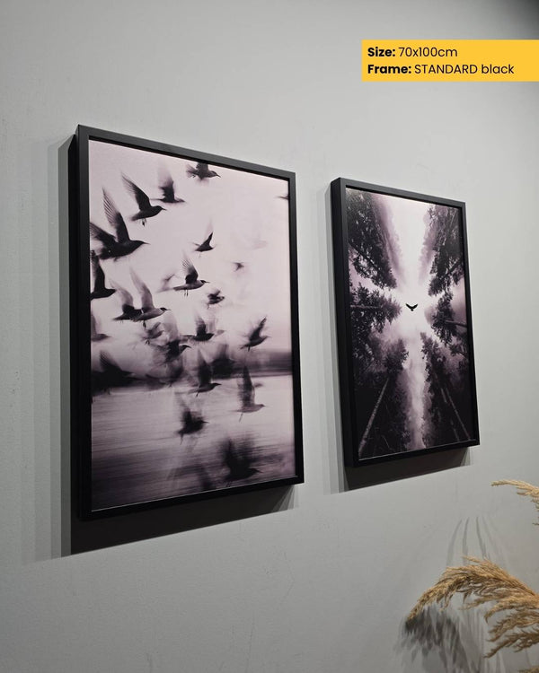 Two framed artworks on a wall with a size and frame type label.