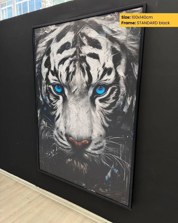 Framed artwork of a white tiger with blue eyes on a black wall.