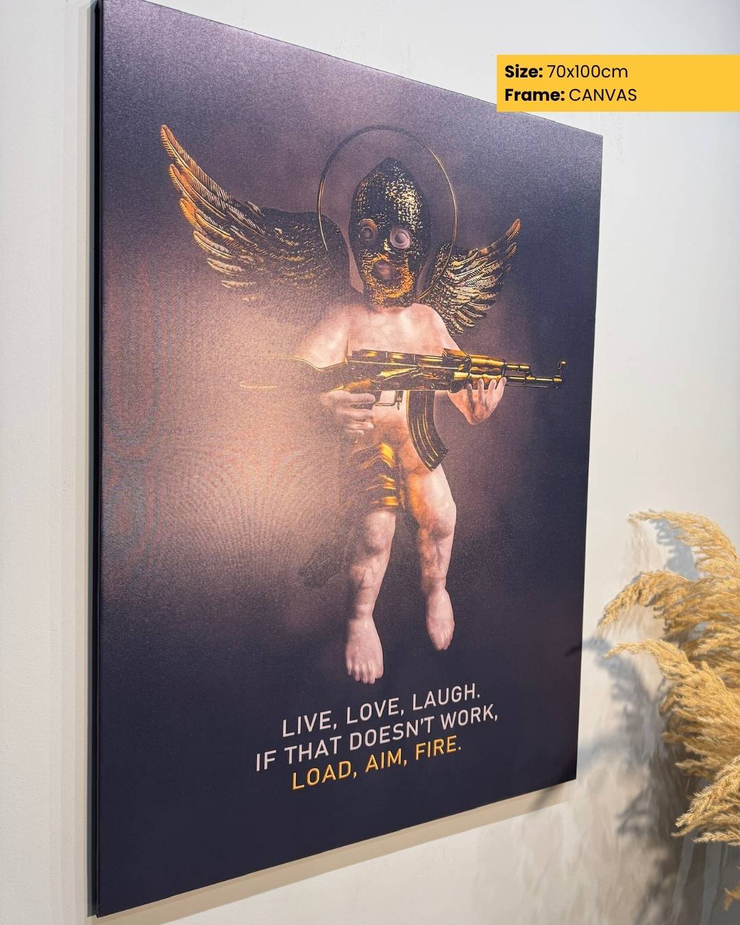 Canvas print of an angel holding a rifle with humorous text on a wall.