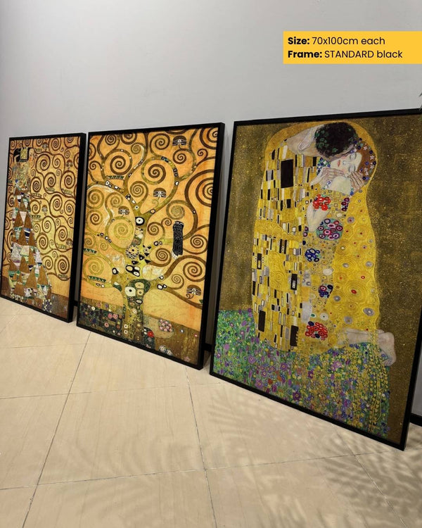 Three framed artworks resembling 'The Kiss' by Gustav Klimt on a tiled floor.