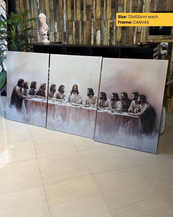 Triptych painting of 'The Last Supper' on a wooden floor with a decorative wall in the background.
