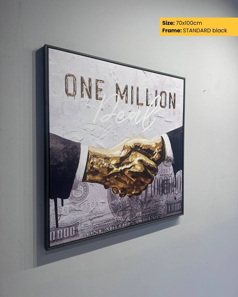Framed artwork with a handshake and text 'One Million' on a gray wall.