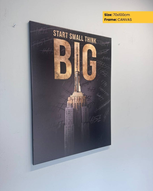 Canvas print with motivational quote 'Start Small Think Big' and Empire State Building silhouette on a white wall.