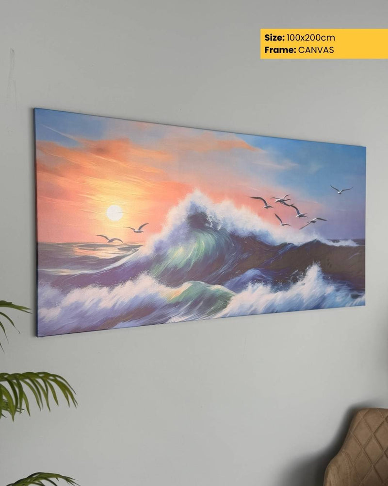 Canvas print of a sunset over the ocean with waves and birds, mounted on a wall.