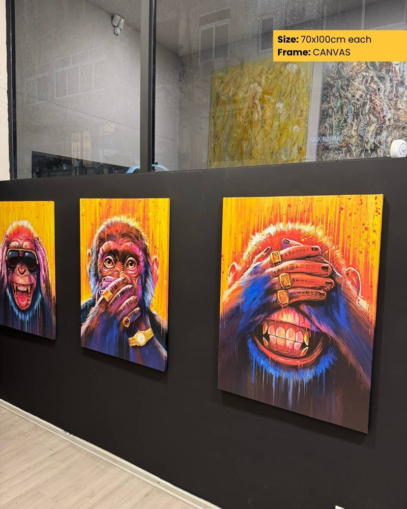 Three colorful paintings of apes on a black wall.
