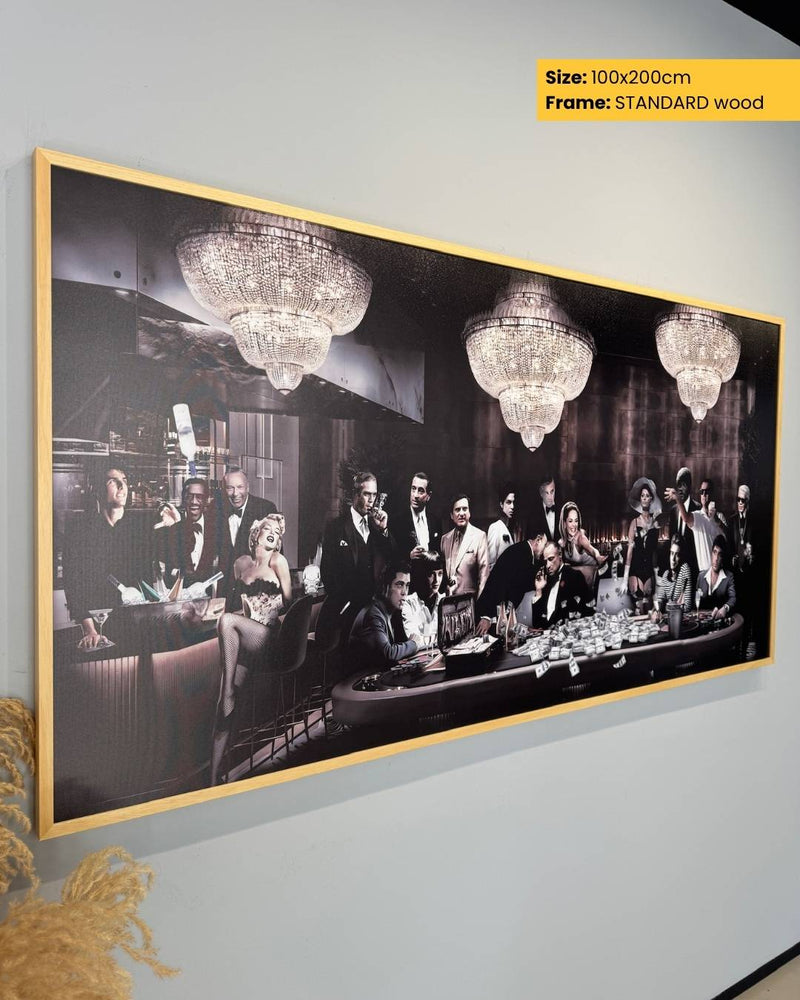 Framed artwork of a famous painting with chandeliers on a wall.
