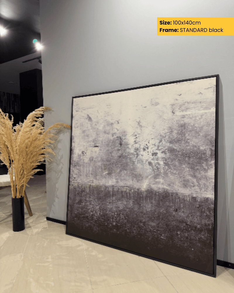 Large abstract painting in a black frame on a wall with decorative plants.
