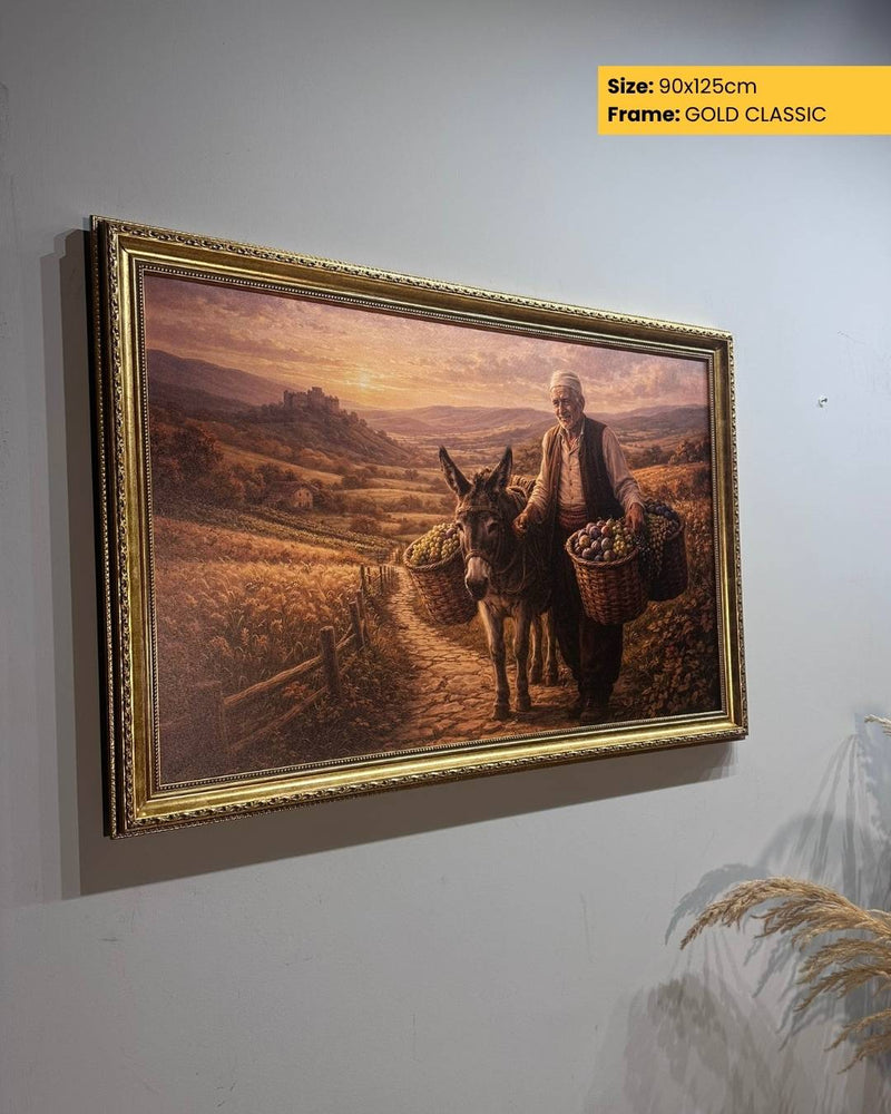 Framed painting of a man with a donkey and baskets on a wall.