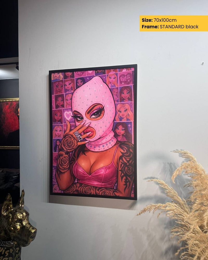 Framed artwork of a woman wearing a pink mask on a wall.
