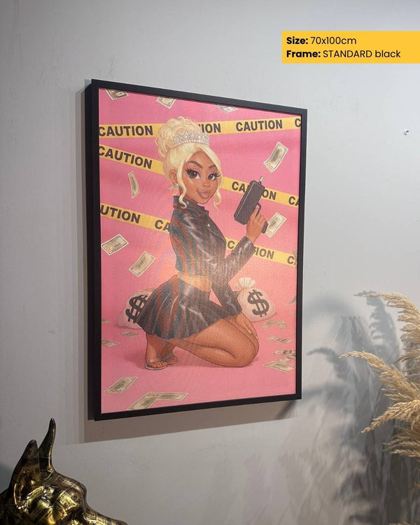 Framed artwork of a stylized character on a pink background with 'CAUTION' tape, held against a gray wall.