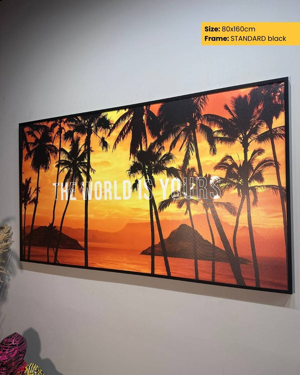 Framed artwork with palm trees and 'The World is Yours' text on a sunset background.