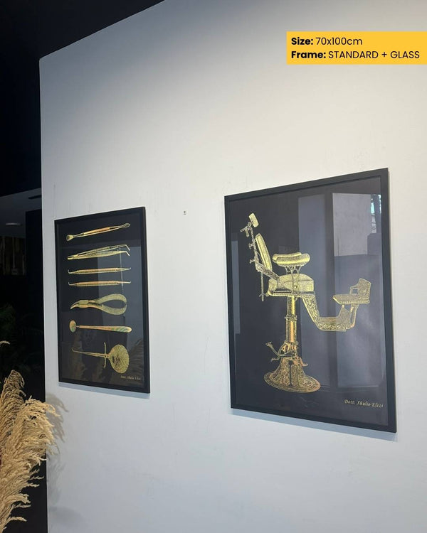Framed artwork of a barber chair and tools on a white wall.