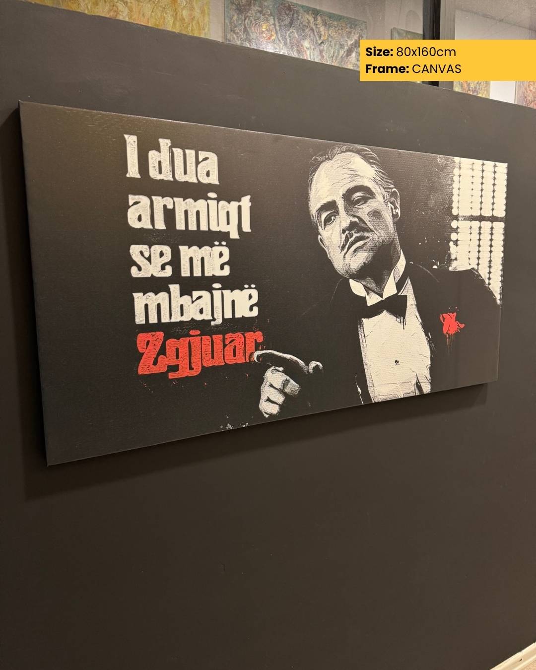 Canvas print with a famous quote and a portrait of a man in a suit on a dark background.