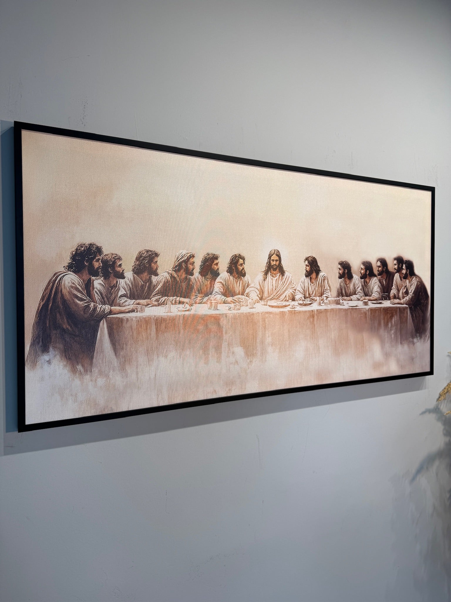 Framed artwork of 'The Last Supper' on a wall