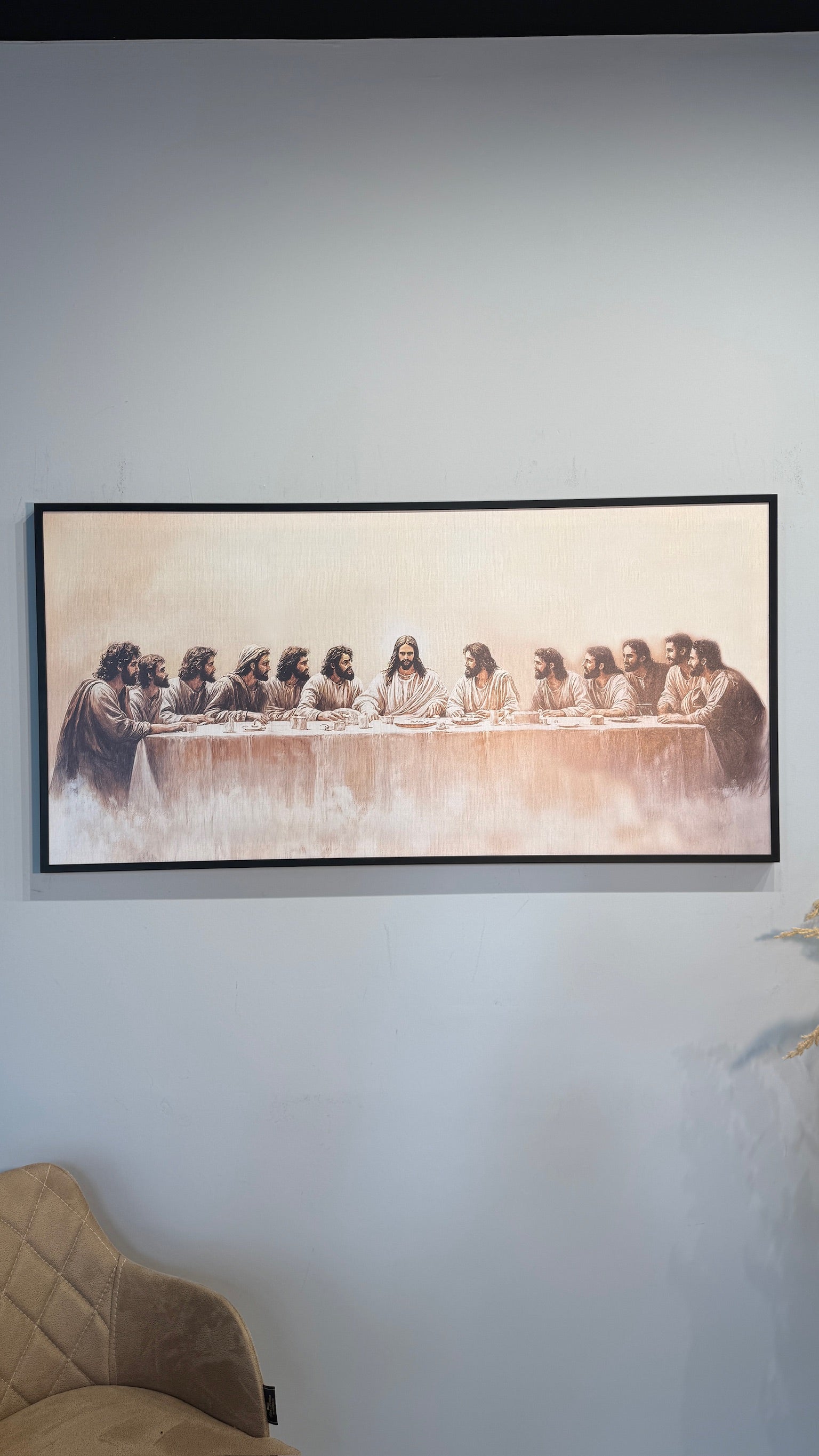 Framed artwork of 'The Last Supper' on a wall.