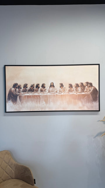 Framed artwork of 'The Last Supper' on a wall.