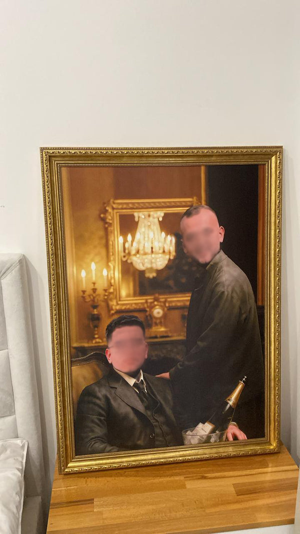 Two people in formal attire reflected in a gold-framed mirror with a chandelier in the background.