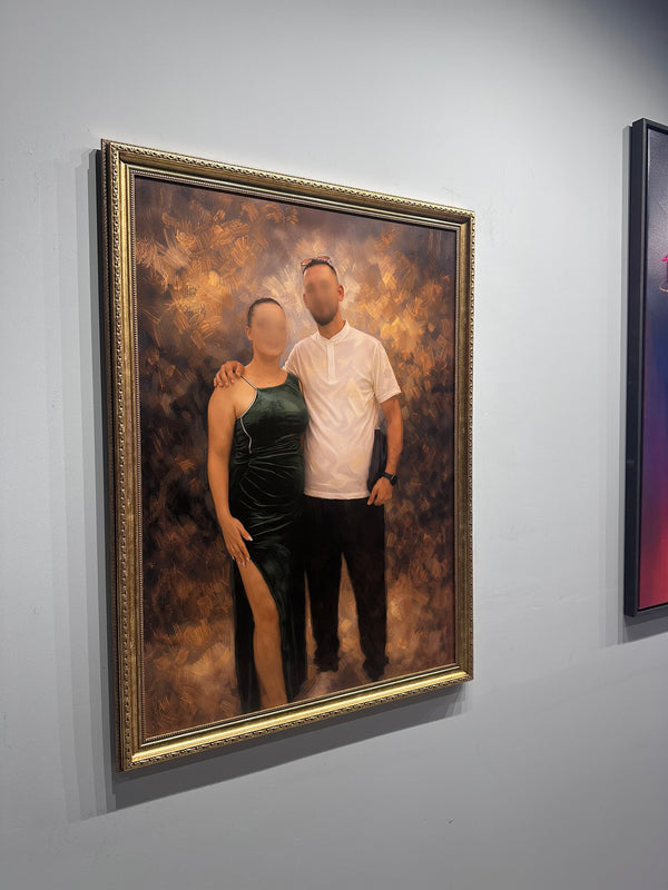 Framed portrait of two people on a gray wall