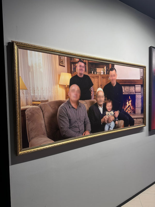 Framed family photo on a wall with blurred faces