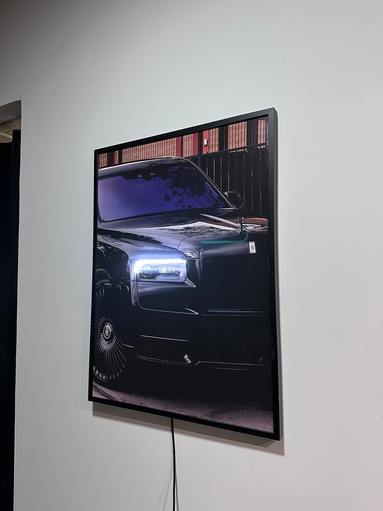 Car displayed on a wall with a white background