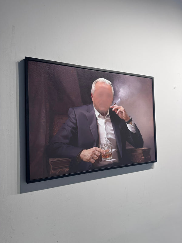 Framed artwork of a man smoking a cigarette and holding a glass on a white wall.