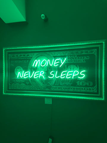 Neon sign with 'Money Never Sleeps' text on a green background