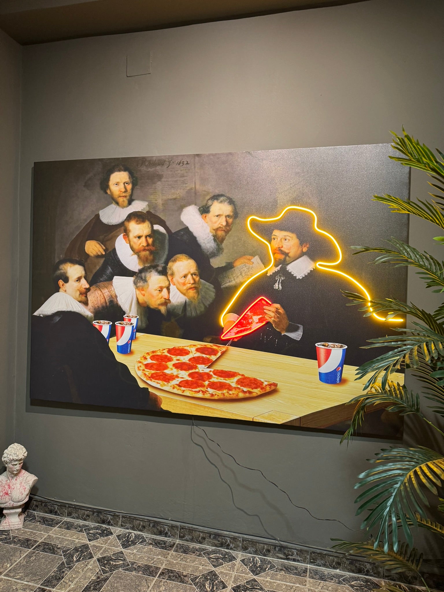 Mural of classical painting with modern elements like a pizza and neon lights, featuring a plant on the right.