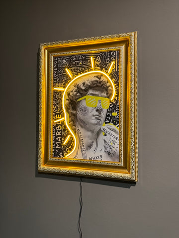 Framed artwork with a classical statue silhouette and neon yellow accents on a dark background