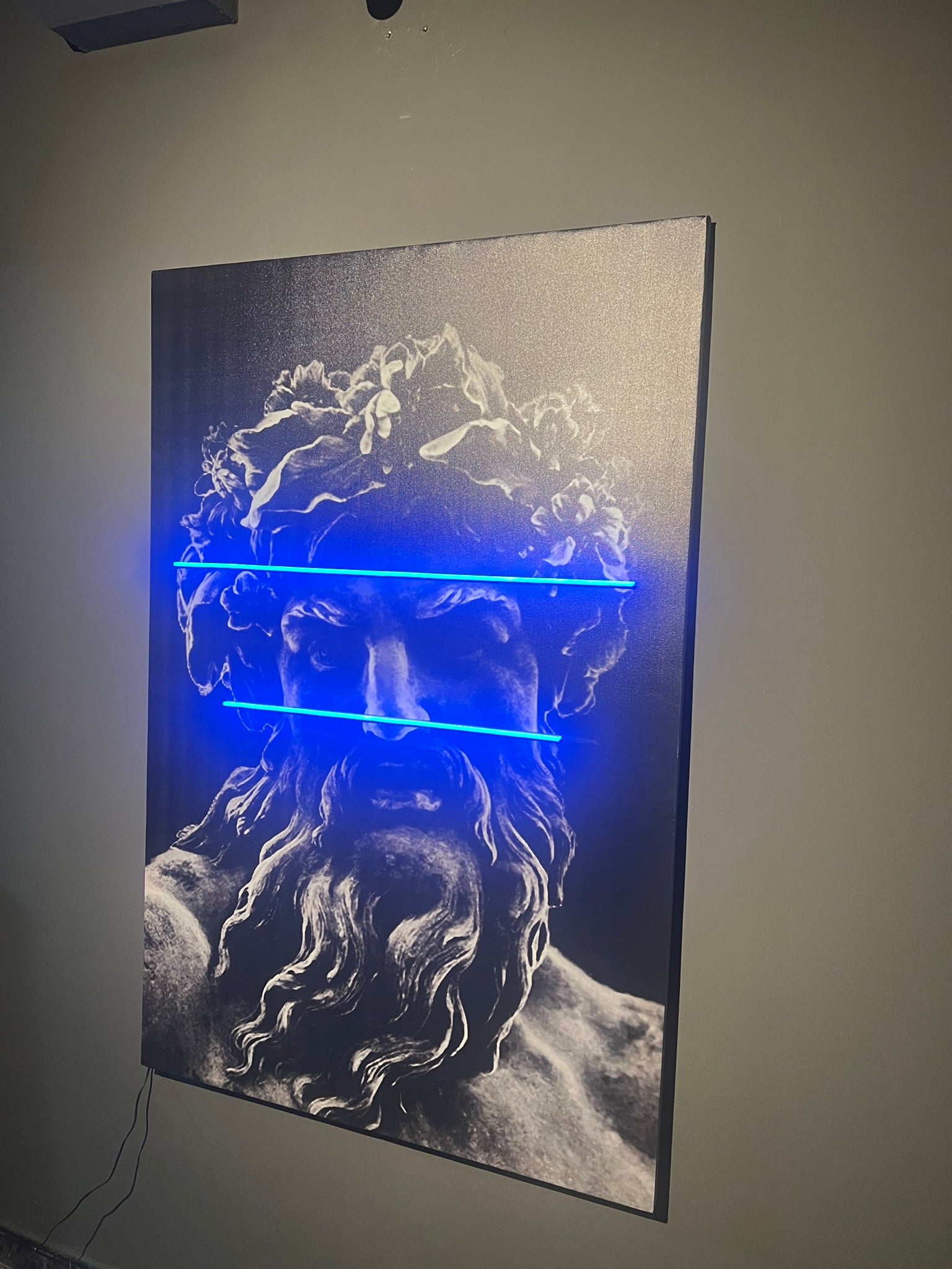 Stylized depiction of a classical statue with blue lighting on a gray wall