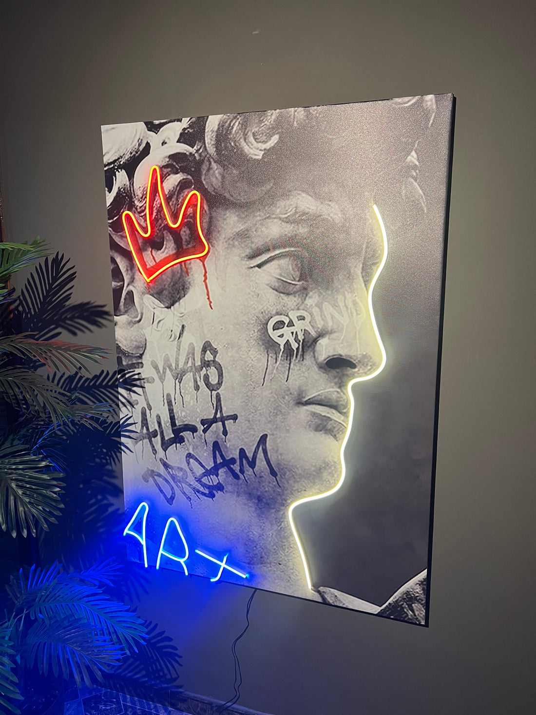 Neon art piece with a stylized face and text on a dark background