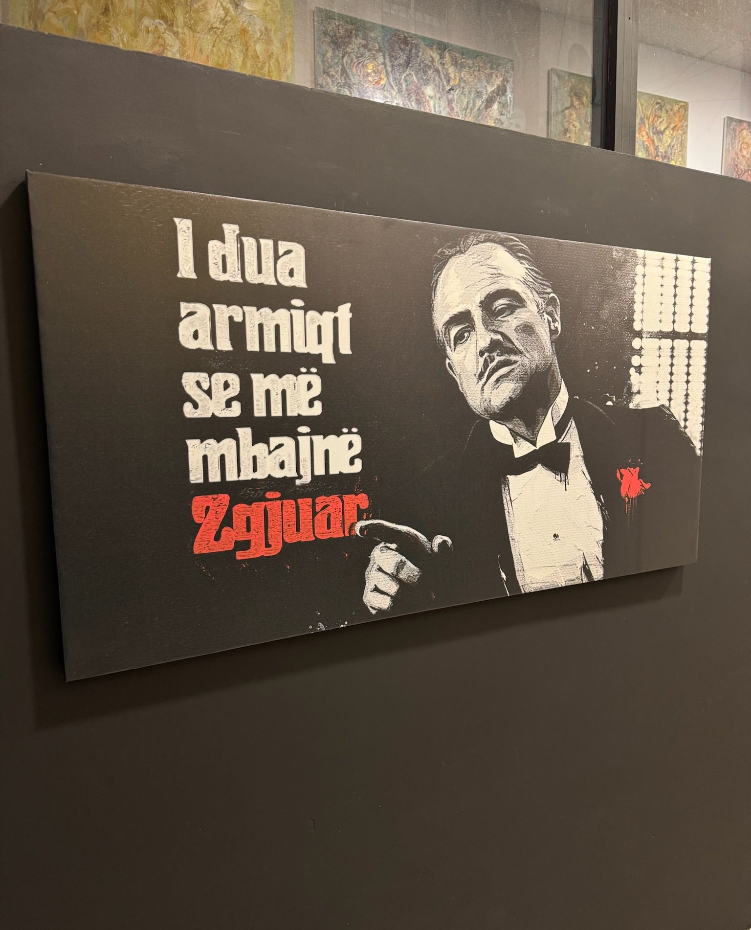 Canvas print with a famous line from 'The Godfather' on a dark wall.