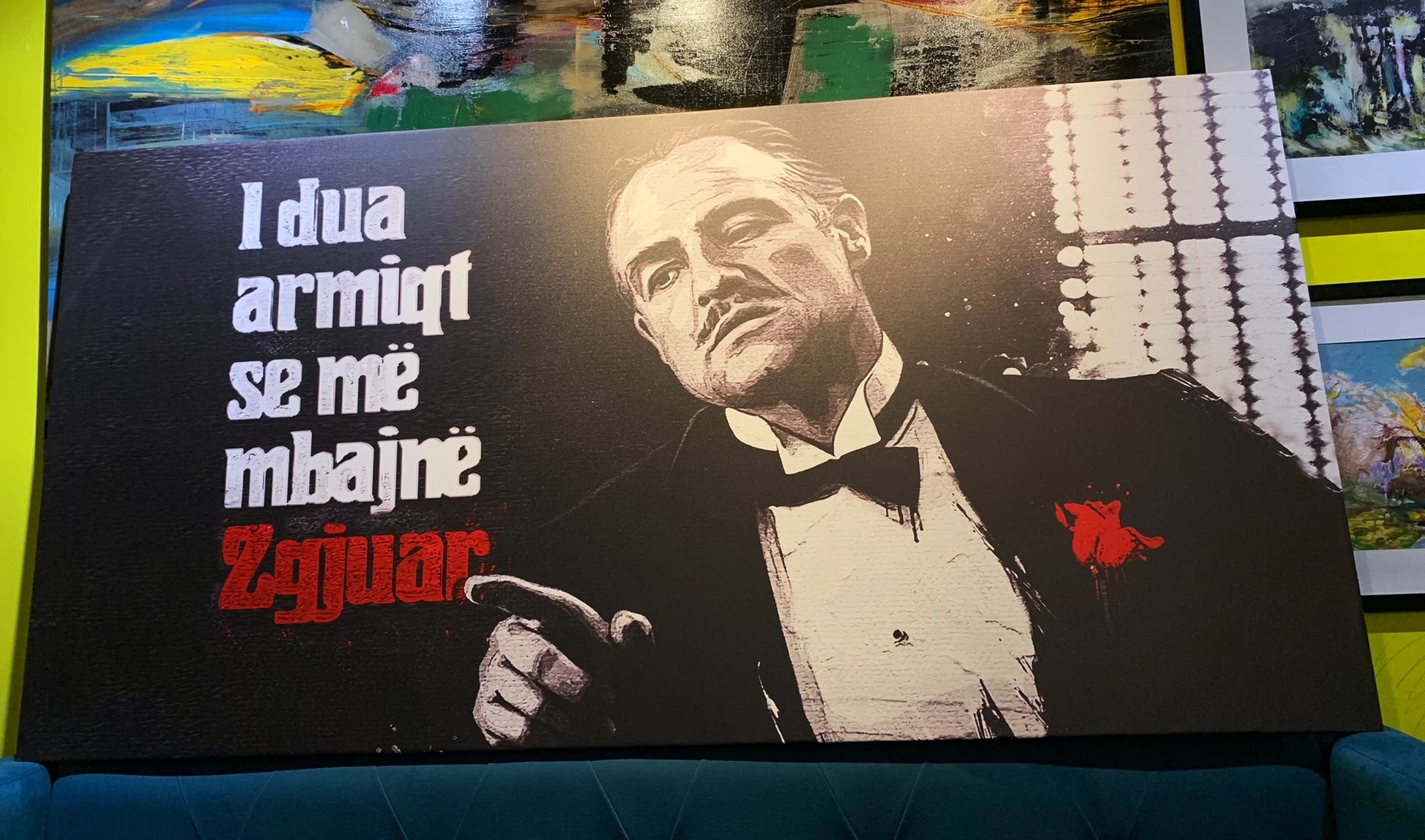 Poster of a man in a suit with text on a couch