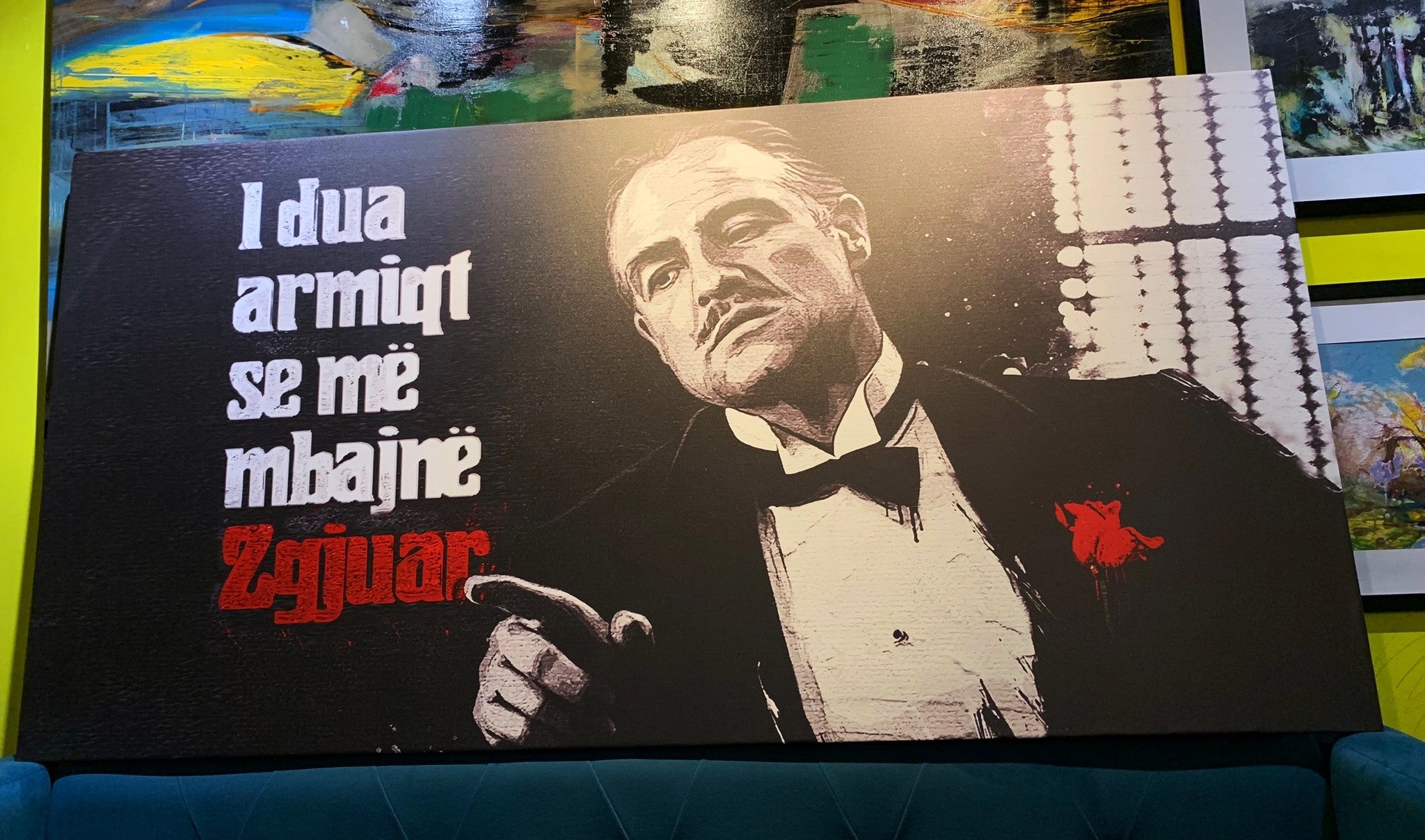 Poster of a man in a suit with text on a couch