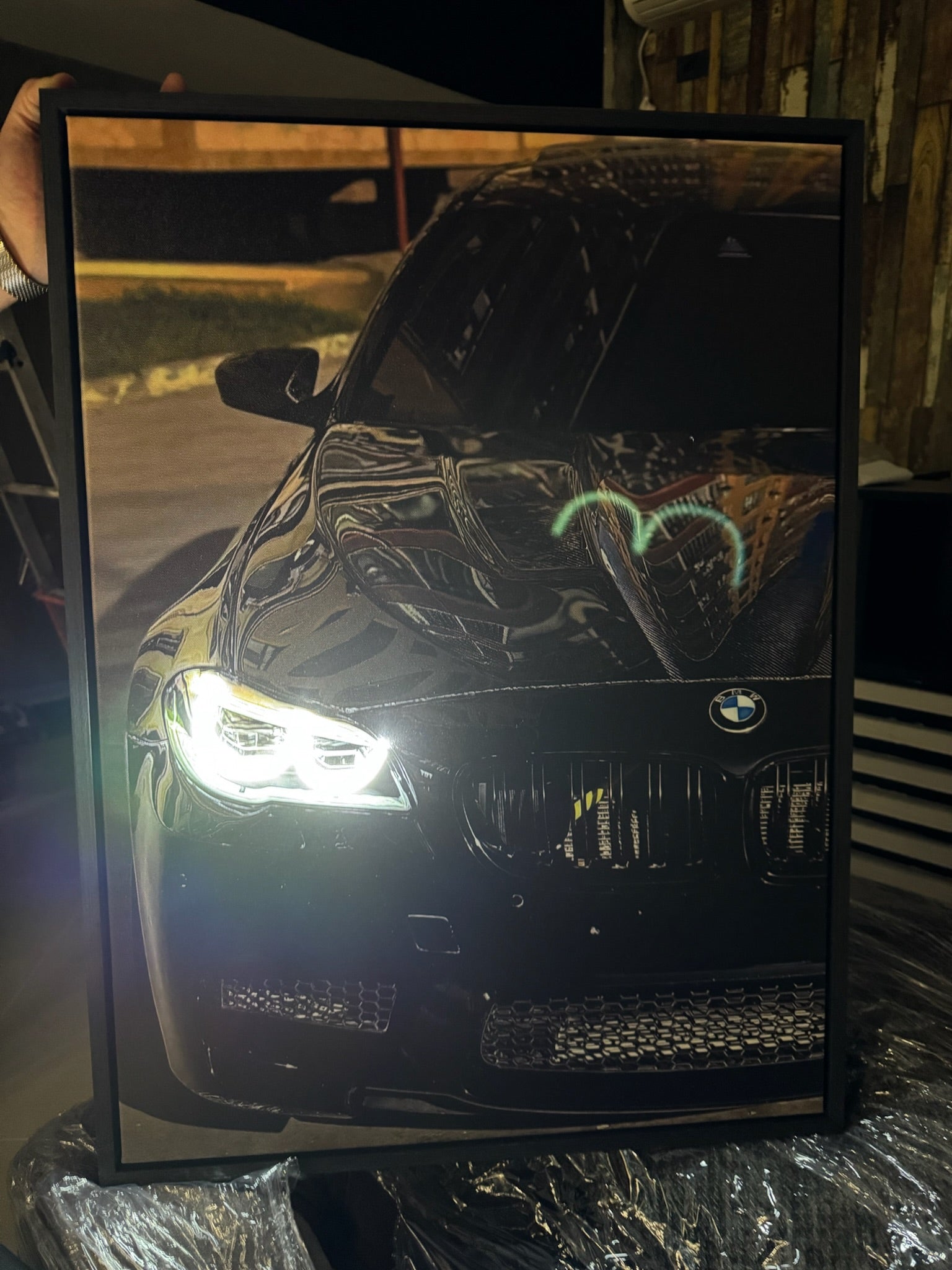 Framed picture of a BMW car with reflective surface